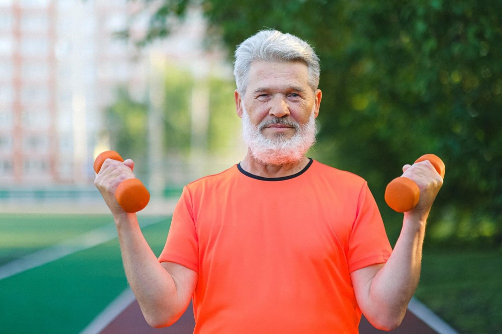 older man lifting weights